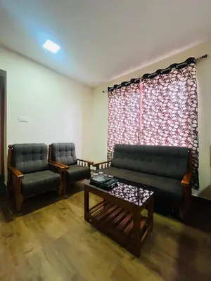 a living room with two couches and a coffee table at Green Hill in Coonoor