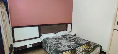 a small bedroom with a bed in a room at Hotelsapphire in Ooty