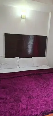 a bedroom with a bed with a purple rug at The Green Regency Annexe in Munnar