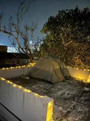a tent sitting on the ground with lights at Dragster Homes Alwaye in Alwaye