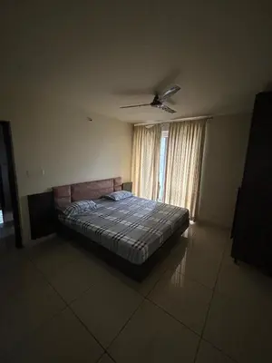a bedroom with a bed and a window at Falcon Heights in Mysore