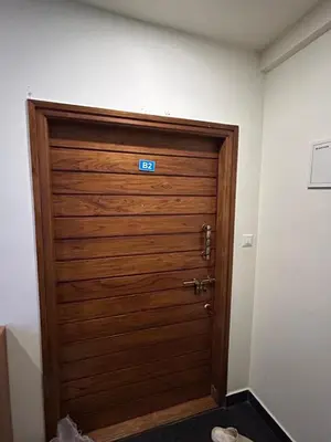 a wooden door with a sign on top of it at Falcon Heights in Mysore