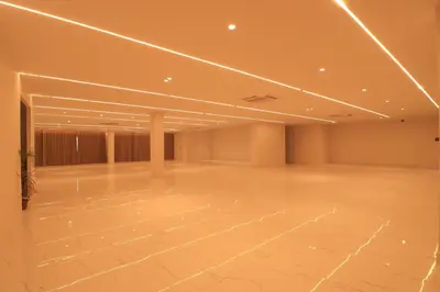a large empty room with lights on the ceiling at Hotel Shellmark in Elivāla