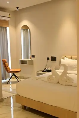 a bedroom with a bed with two swans on it at Hotel Shellmark in Elivāla
