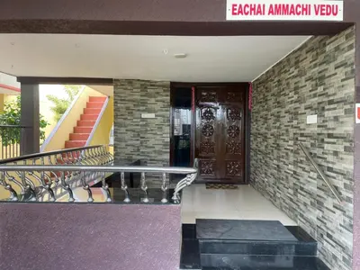 a staircase leading to a building with a revolving door at Eden luxury stay saravanampatti in Coimbatore