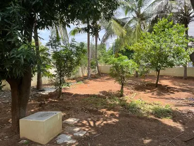 a concrete bench sitting in the middle of a yard with trees at Eden luxury stay saravanampatti in Coimbatore