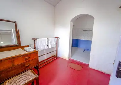 a bathroom with a sink and a mirror and a shower at Arivikad Tea Bungalow Munnar By VOYE HOMES in Munnar