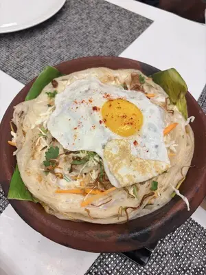 a bowl of food with an egg on top at Seawind in Kannur