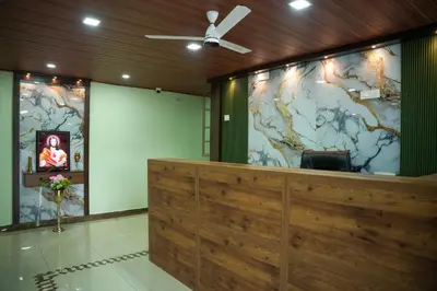 a lobby with a large mural of a world on the wall at TREE 9 COCHIN AiRPORT HOTEL in Nedumbassery