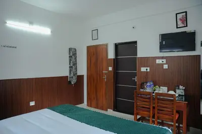 a bedroom with a bed and a flat screen tv at TREE 9 COCHIN AiRPORT HOTEL in Nedumbassery