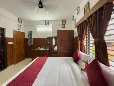 a bedroom with a bed and a dining room at TREE 9 COCHIN AiRPORT HOTEL in Nedumbassery