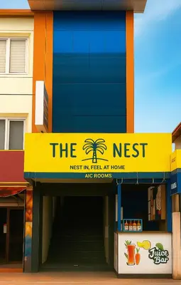 a restaurant with a yellow sign on the side of a building at The Nest in Trichūr