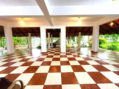 an empty lobby with a checkered floor in a house at WAYANAD RESORT VILLA Service in Meppādi