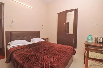 a bedroom with a large bed with a red blanket at HIGHLAND Hills in Coonoor