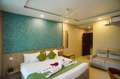 a bedroom with a bed and a couch at Sreepathi Prayag 11 Service Apartment in Guruvāyūr
