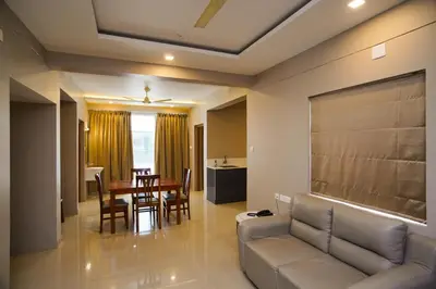 a living room with a couch and a table at Sreepathi Prayag 11 Service Apartment in Guruvāyūr