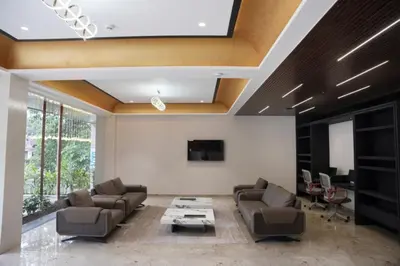 a living room with couches and a table at Alba Regency in Guruvāyūr