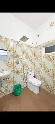 a bathroom with a toilet and a sink at Seascape Homestay Cherai Beach in Cochin