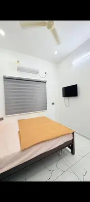 a bedroom with a bed in a room with a window at Seascape Homestay Cherai Beach in Cochin