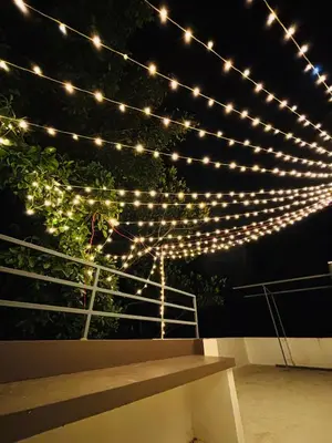 a string of lights hanging from a fence at Seascape Homestay Cherai Beach in Cochin