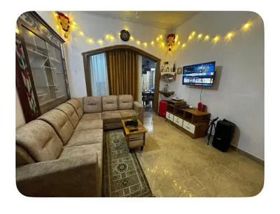 a living room with a couch and a tv at Nirvana Stays Banasura, Wayanad in Wayanad