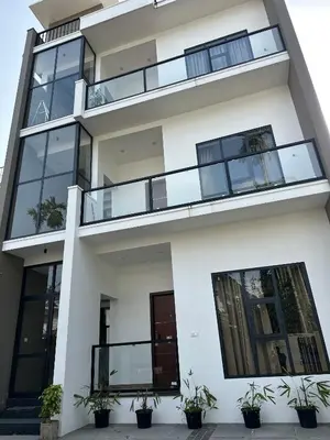 an apartment building with large windows and potted plants at Zainab in Kozhikode