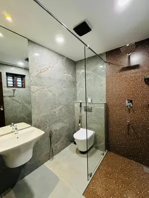 a bathroom with a toilet and a sink and a shower at Zainab in Kozhikode