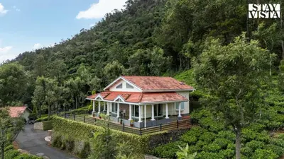 a house with a red roof on a hill at StayVista at Farview Suite Serenity with Lawn in Kotagiri