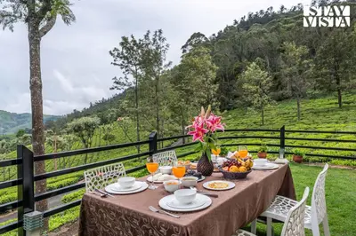 a table with food and fruit on it with a view at StayVista at Farview Suite Serenity with Lawn in Kotagiri