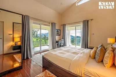 a bedroom with a large bed with a large window at StayVista at Farview Suite Serenity with Lawn in Kotagiri