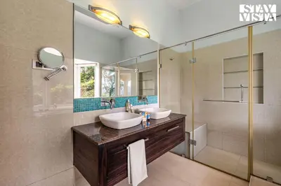 a bathroom with two sinks and a shower at StayVista at Farview Suite Serenity with Lawn in Kotagiri