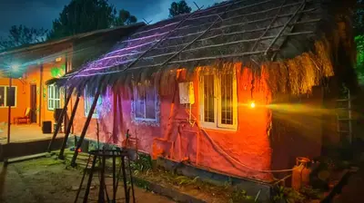 a colorful house with lights on the side of it at Madama Mudhouse Edenwood Retreats in Kanthalloor