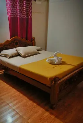 a bed with a toy duck sitting on top of it at Madama Mudhouse Edenwood Retreats in Kanthalloor