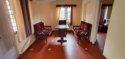 a room with three chairs and a table in a room at Ooty FernCrest in Ooty