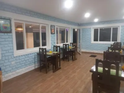 a dining room with tables and chairs in a restaurant at Ooty FernCrest in Ooty