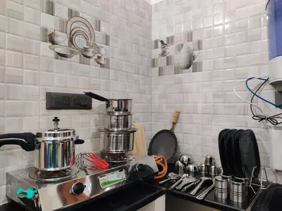 a kitchen with a stove with a pot on it at Kamadhenu Homestay, Comapact 1BHK OPP Mysore zoo, in Mysore