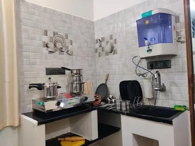 a small kitchen with a sink and a mixer at Kamadhenu Homestay, Comapact 1BHK OPP Mysore zoo, in Mysore