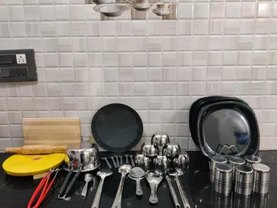 a kitchen counter with a bunch of utensils and mirrors at Kamadhenu Homestay, Comapact 2BHK OPP Mysore zoo, A in Mysore