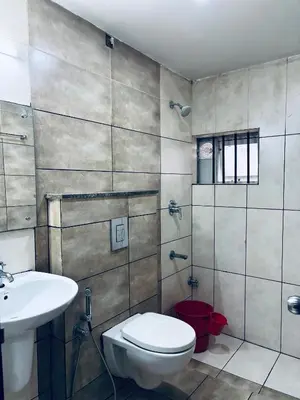 a bathroom with a toilet and a sink at Hotel Malabar Grand in Perintalmanna