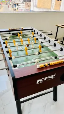 a pool table with balls and bats on it at LF Easybeds in Kozhikode