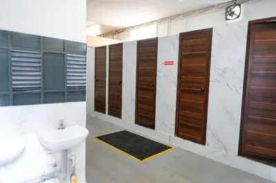 a bathroom with wooden doors and a sink at LF Easybeds in Kozhikode