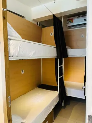 a room with two bunk beds in a room at Lowfare Hotels Medical College in Kozhikode