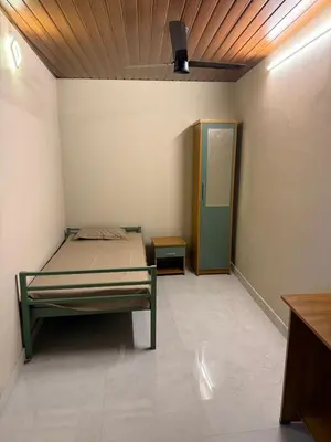 a room with a bed and a door in it at HG Tower 2 in Kunnamangalam