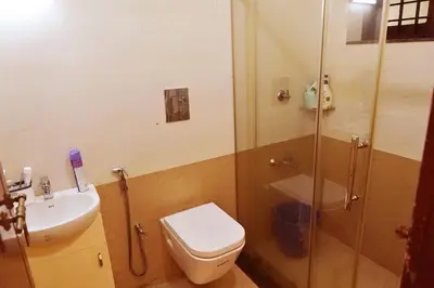 a bathroom with a shower and a toilet and a sink at Niki Haven in Kāladi