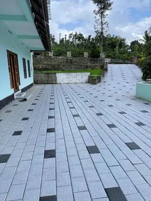 an empty courtyard of a house with a building at Wayanad Evergreen Farmhouse in Sultan Bathery