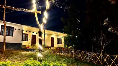 a house at night with lights in front of it at Chembani Holidays and Resorts Kanthalloor in Kanthalloor