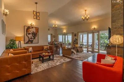 a living room with leather furniture and a fireplace at EKOSTAY - Skyfall Dew Drops in Ooty