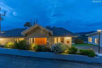 a house with lights in front of it at night at EKOSTAY - Skyfall Dew Drops in Ooty