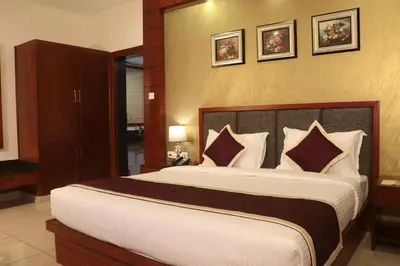 a bedroom with a large bed in a room at Bhasuri Inn Guruvayoor in Guruvāyūr