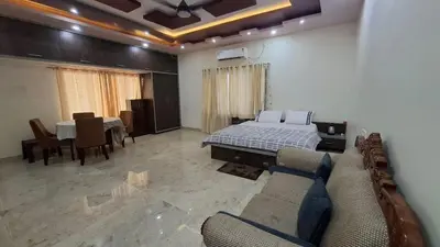 a living room with a bed and a dining room at Shan stay Home 2 in Mysore